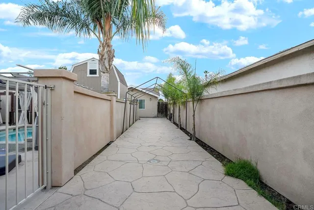 a kitchen with stainless steel appliances kitchen island granite countertop a table chairs sink and microwave