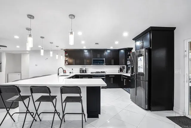 a kitchen with stainless steel appliances and refrigerator