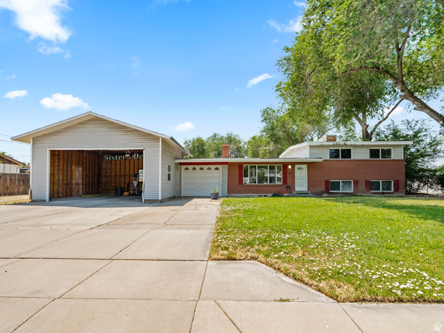 120 Cox Lane Midvale, UT 84047 - Photo 1 of 13 Split-level residence featuring brick and siding facade, a manicured lawn, and a wide concrete driveway