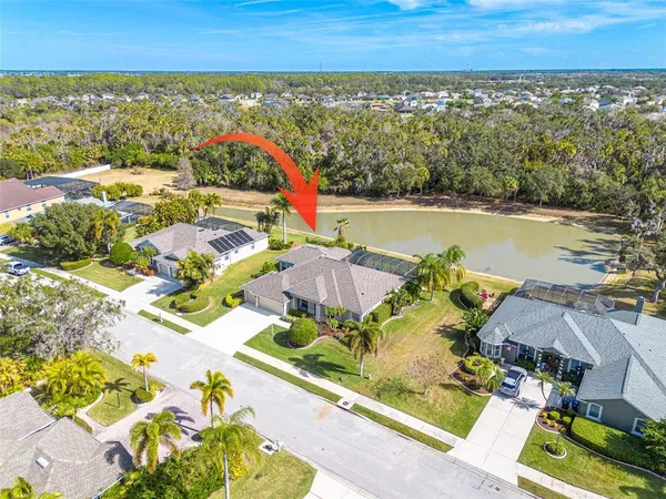 an aerial view of residential houses with outdoor space and swimming pool
