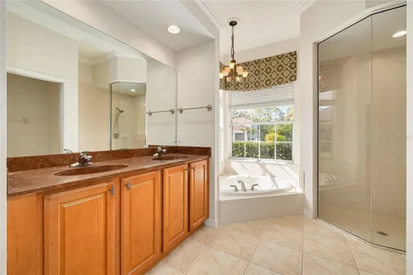 a spacious bathroom with a granite countertop sink a mirror and shower