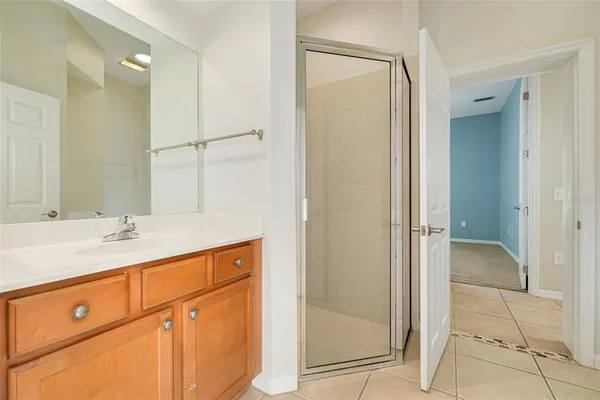 a bathroom with a shower sink and mirror