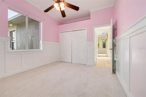 en empty room with fan and entrance