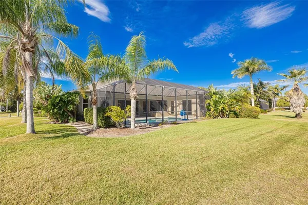 a view of a house with swimming pool and a yard