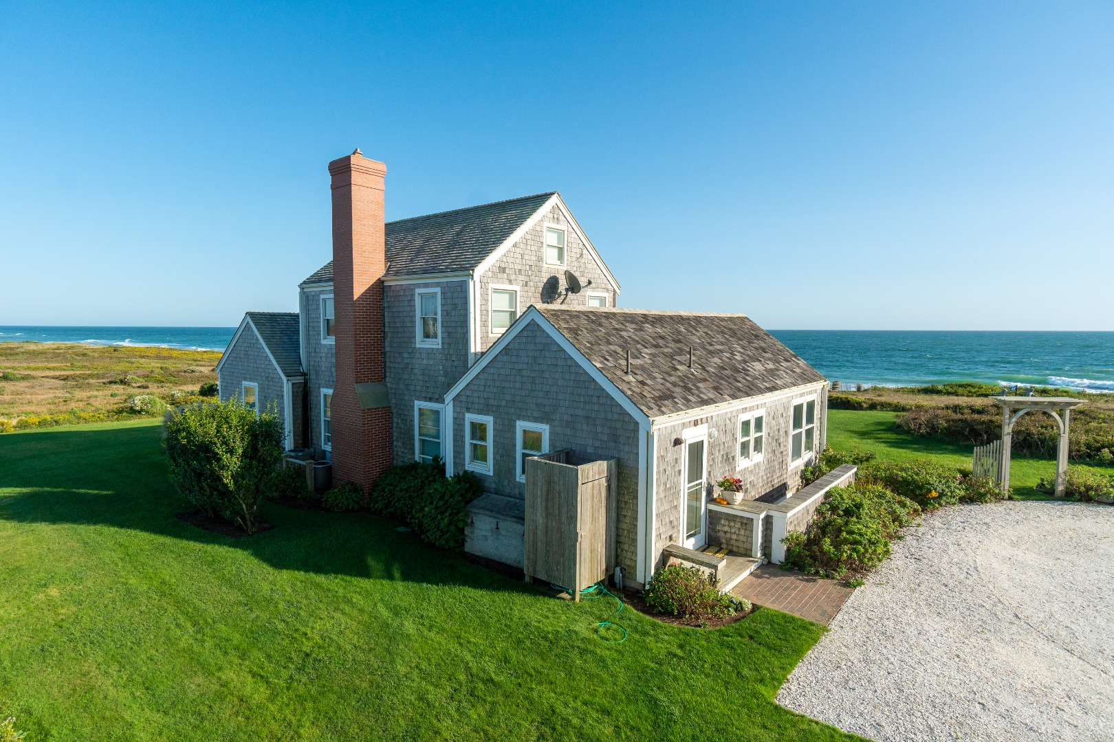 56 R Madequecham Valley Road Nantucket, MA 02554 - Photo 2 of 52 a front view of a house with garden