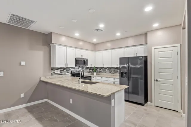 a view of kitchen island a sink wooden floor and living room view