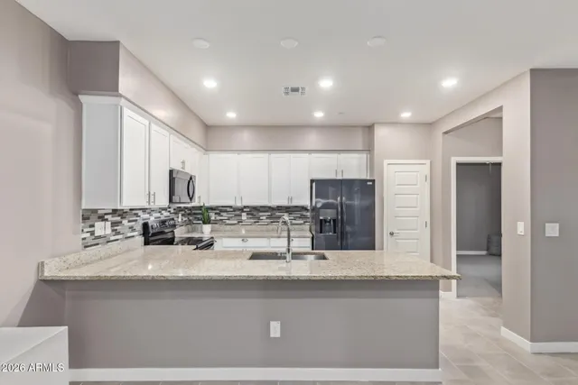 a kitchen with a sink stove and refrigerator