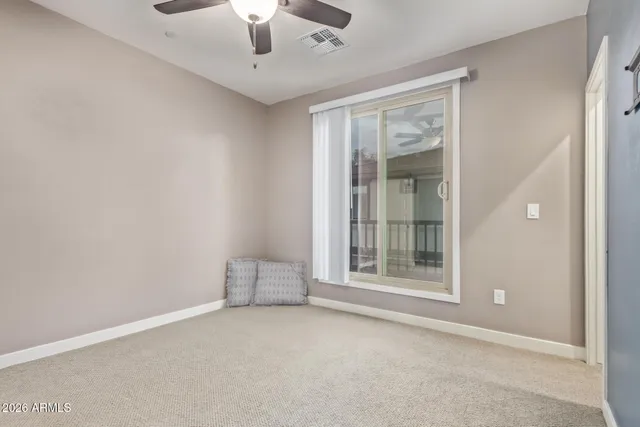 an empty room with closet and windows