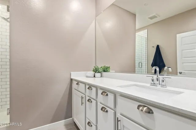 a bathroom with a double vanity sink and a mirror