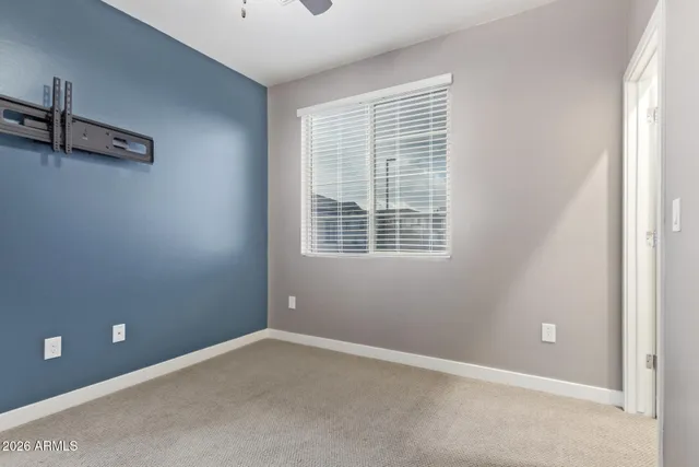 an empty room with a ceiling fan