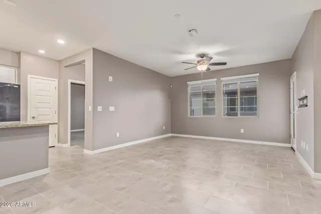 a view of an empty room with a cabinet and a window