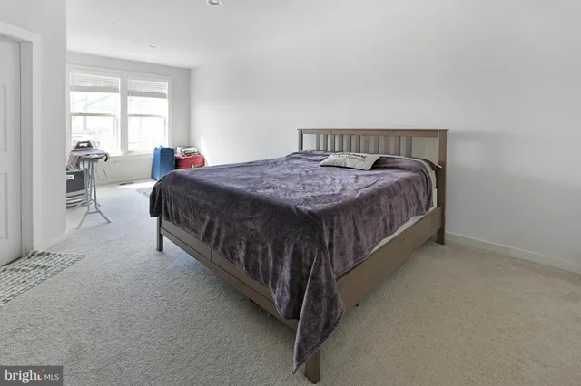 a bed sitting in a bedroom next to a window