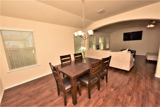 a view of a dining room with furniture and wooden floor