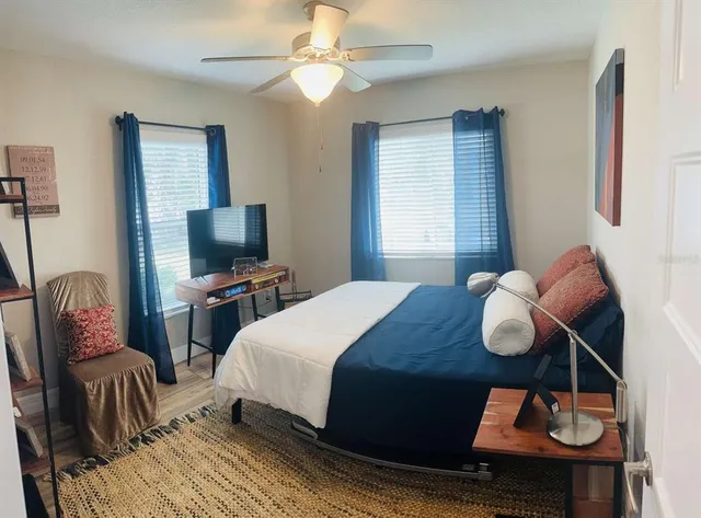 a bedroom with a bed and wooden floor