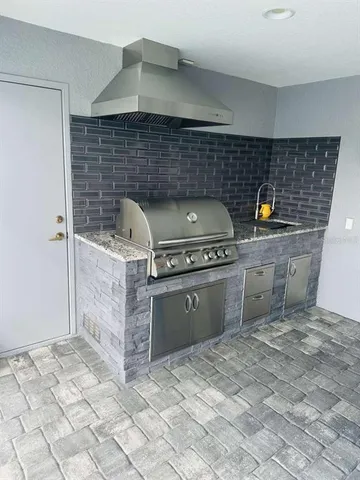 a kitchen with stainless steel appliances kitchen island granite countertop a stove a sink and a microwave