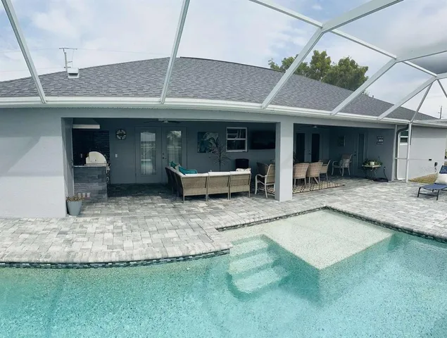 a view of a patio with table and chairs