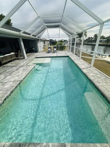 a view of a swimming pool with a patio