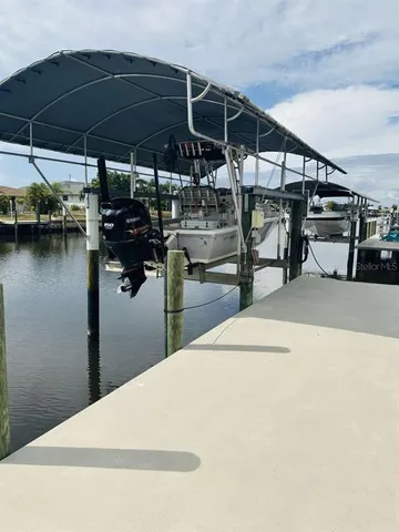 a patio with table and chairs under an umbrella