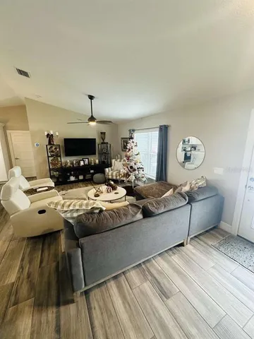 a living room with hard wood flooring and furniture