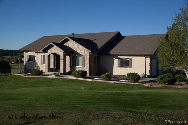 6202 Lorraine Road Larkspur, CO 80118 - Photo 1 of 35 a front view of a house with a garden