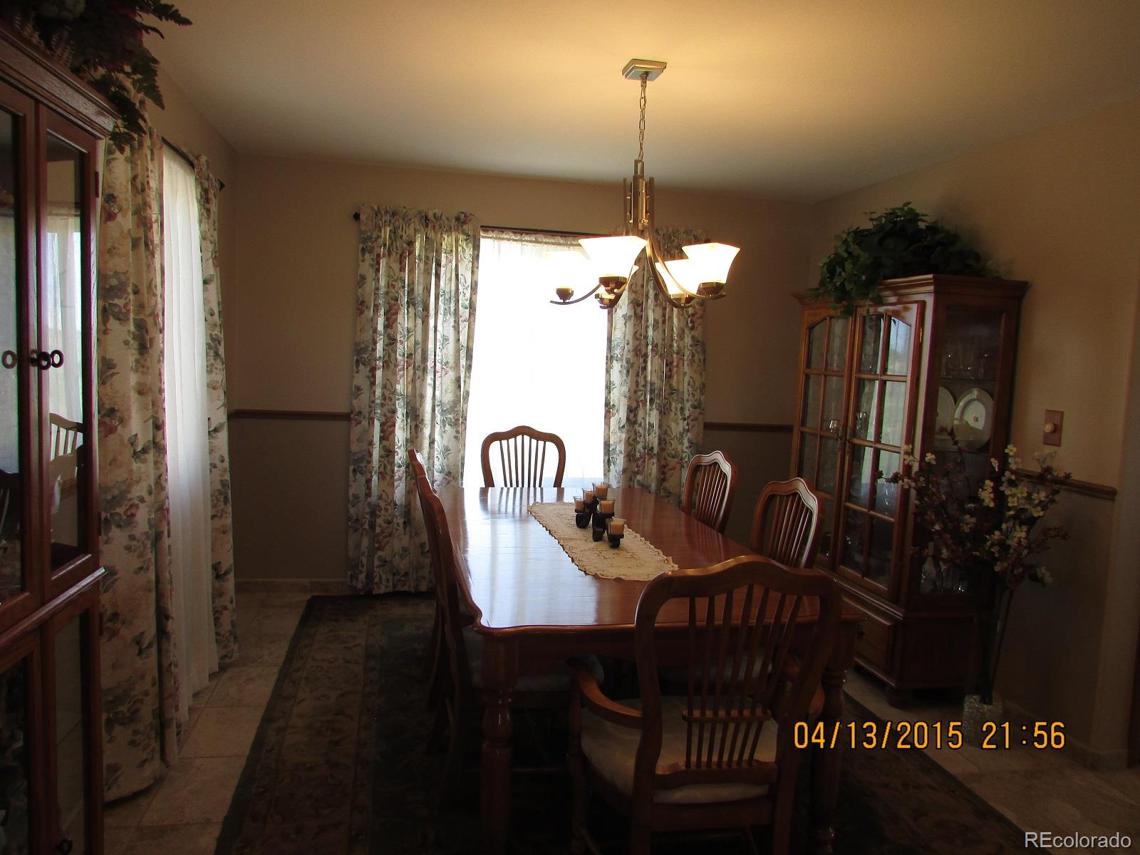 6202 Lorraine Road Larkspur, CO 80118 - Photo 17 of 35 a view of a dining room with furniture window and wooden floor