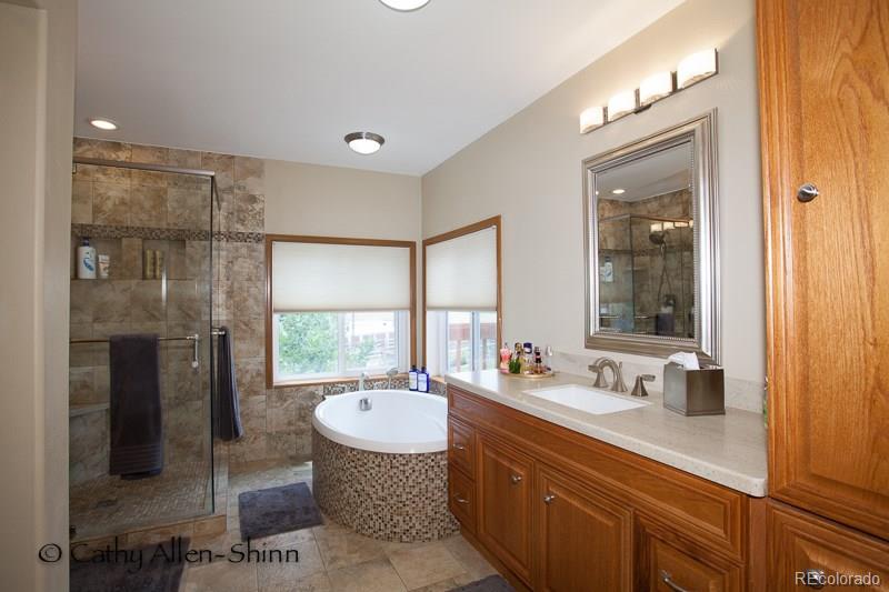 6202 Lorraine Road Larkspur, CO 80118 - Photo 27 of 35 a bathroom with a sink double vanity and a mirror