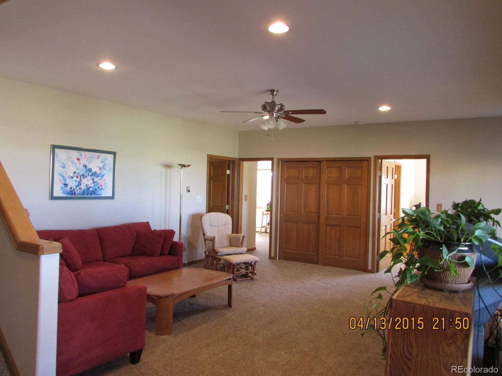 6202 Lorraine Road Larkspur, CO 80118 - Photo 29 of 35 a living room with furniture and a chandelier
