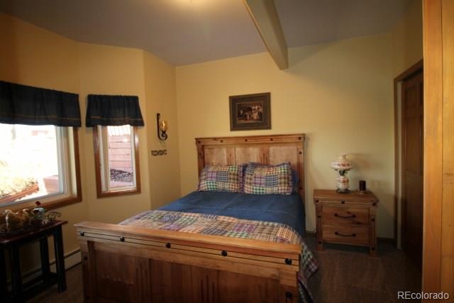 6202 Lorraine Road Larkspur, CO 80118 - Photo 30 of 35 a bedroom with a bed and a window