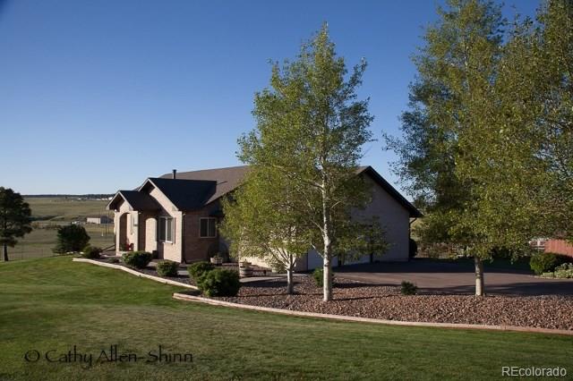 6202 Lorraine Road Larkspur, CO 80118 - Photo 3 of 35 front view of house with a yard