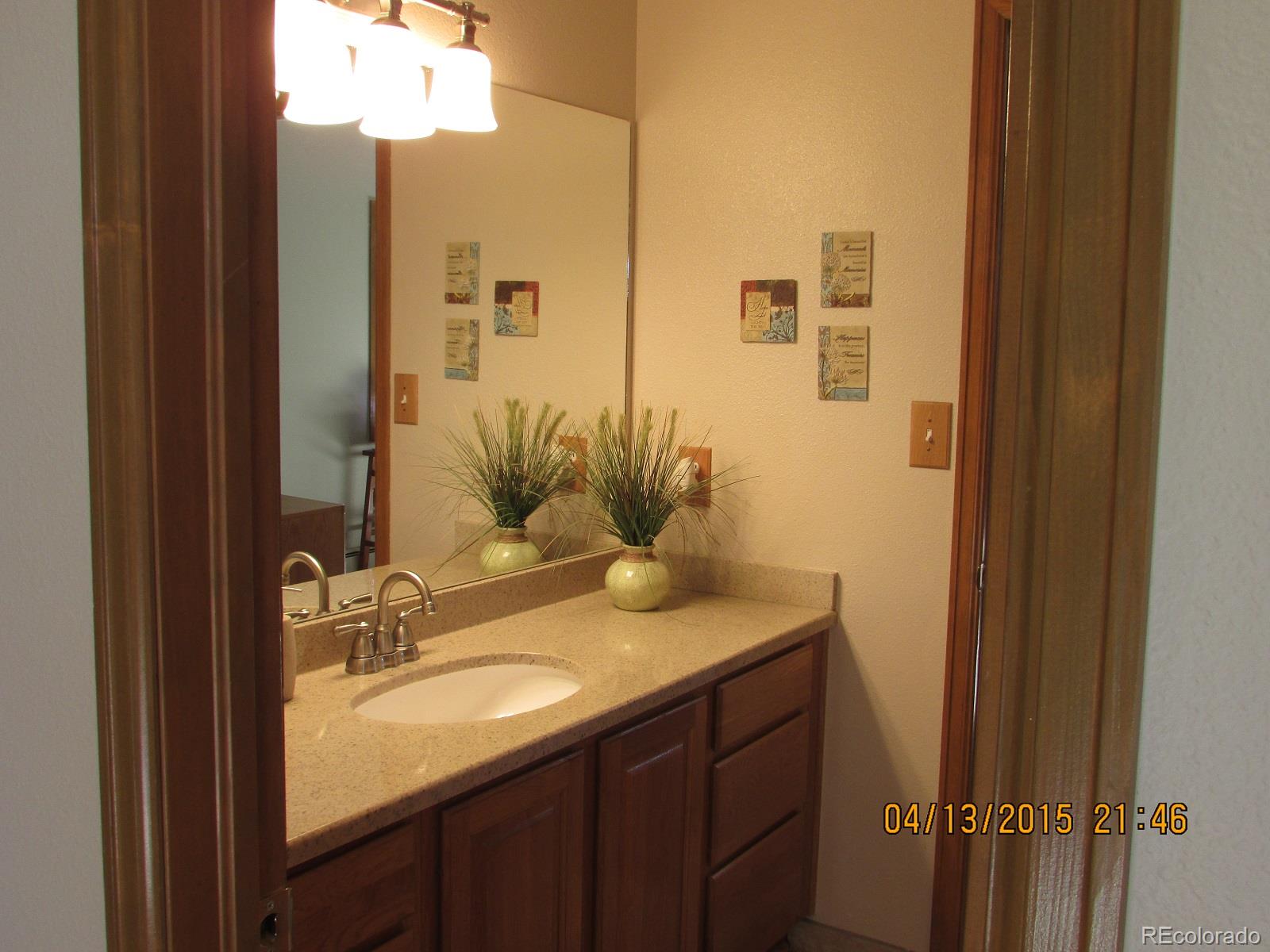 6202 Lorraine Road Larkspur, CO 80118 - Photo 33 of 35 a bathroom with a granite countertop sink and a mirror