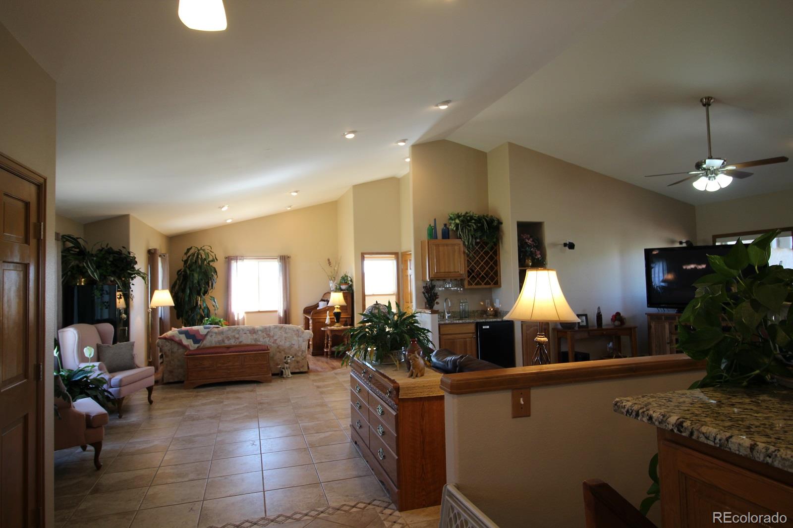 6202 Lorraine Road Larkspur, CO 80118 - Photo 8 of 35 a living room with furniture a lamp and a chandelier
