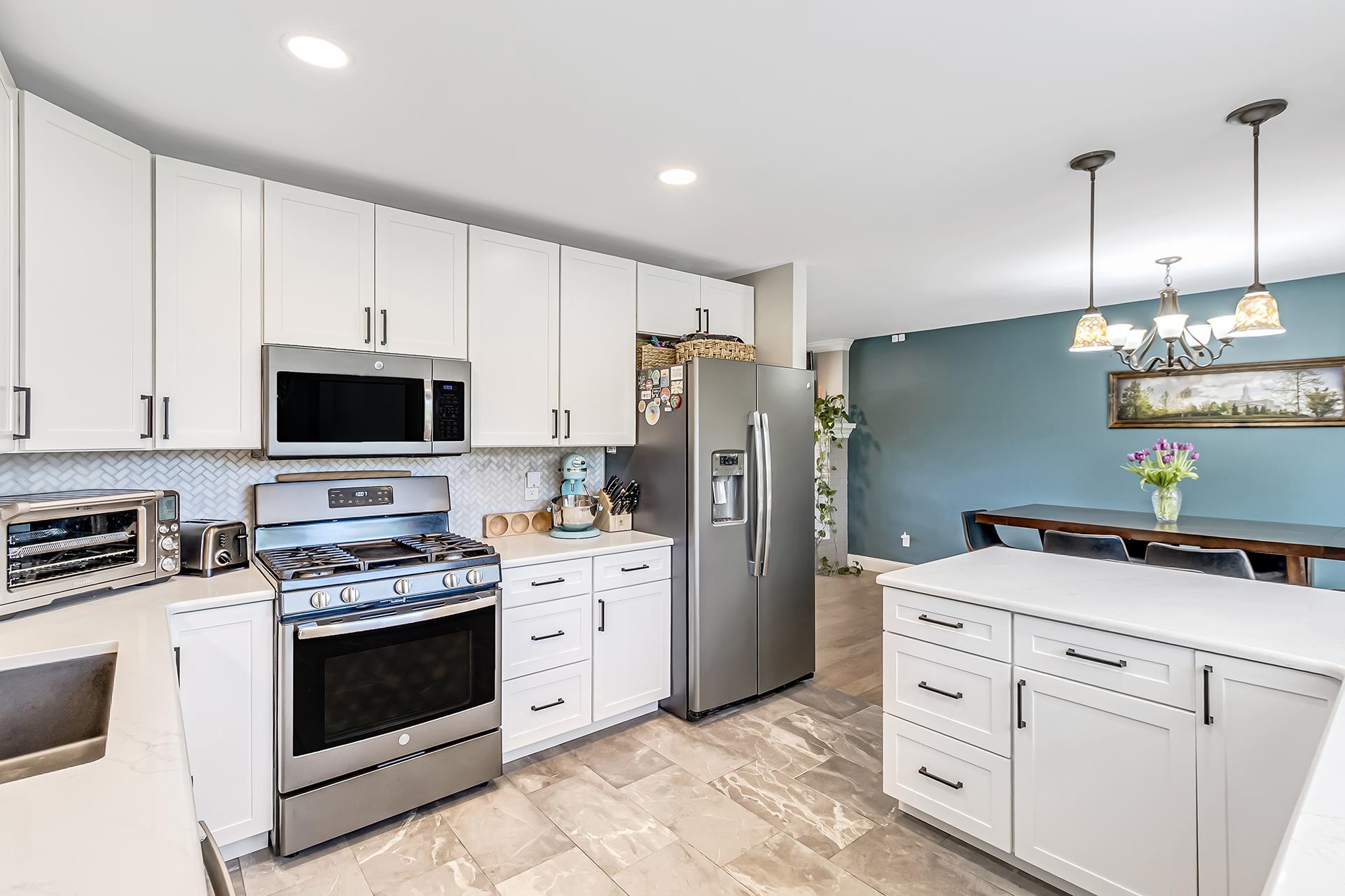 2118 Saguaro Road Grand Junction, CO 81507 - Photo 8 of 42 a kitchen with white cabinets and stainless steel appliances