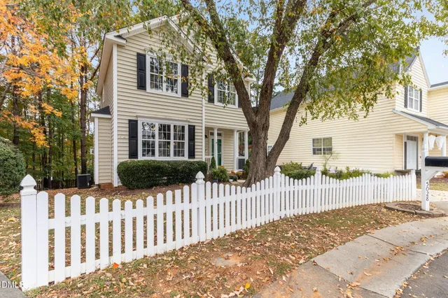 a front view of a house with a fence