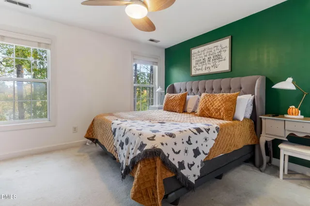 a bedroom with a bed and a painting on the wall