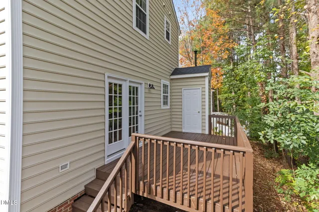 a balcony with wooden floor and trees