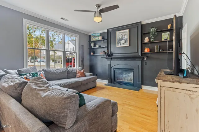 a view of a hallway with wooden floor and furniture