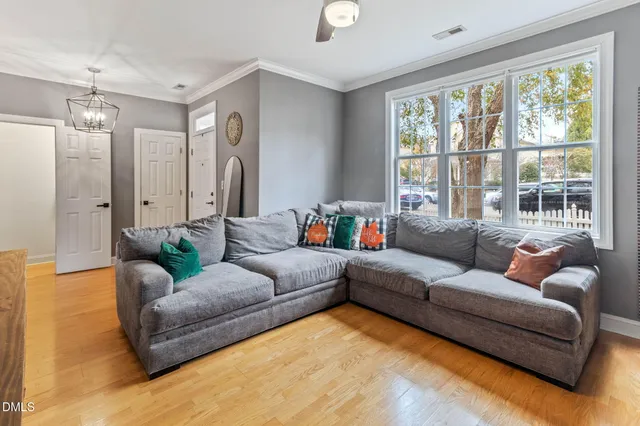 a living room with fireplace furniture and a flat screen tv