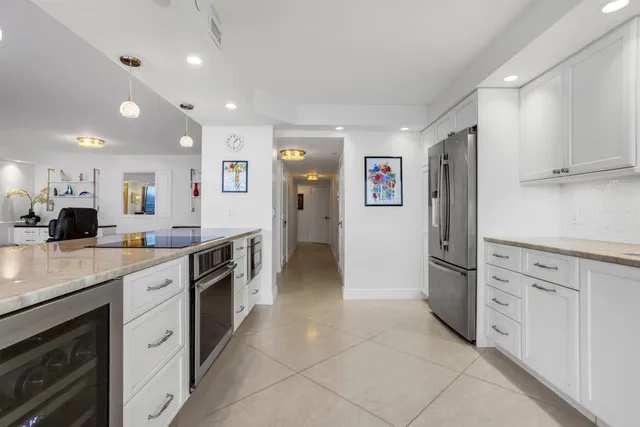 a large kitchen with cabinets and stainless steel appliances