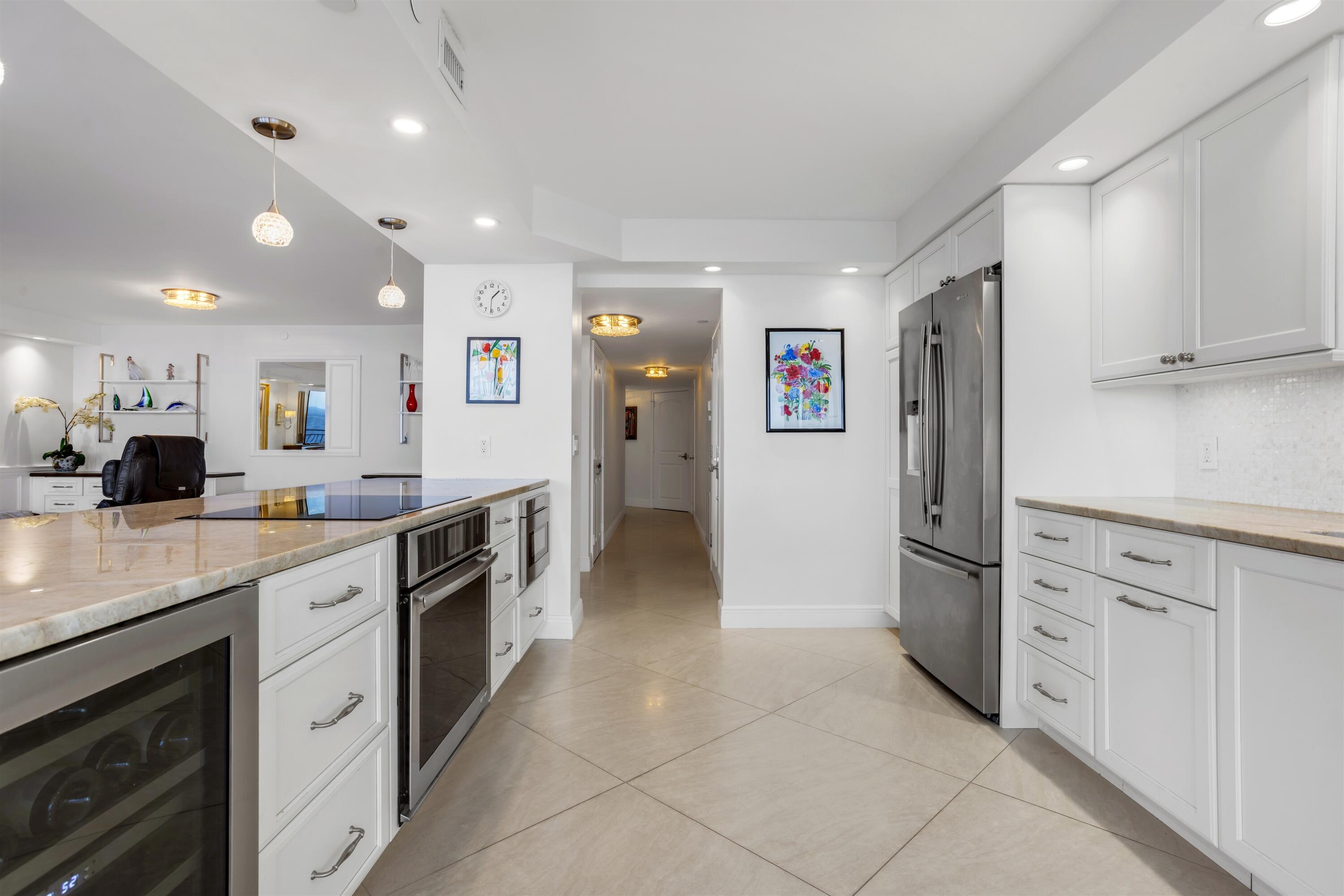1800 South Ocean Boulevard, Unit 6B Boca Raton, FL 33432 - Photo 12 of 34 a large kitchen with cabinets and stainless steel appliances
