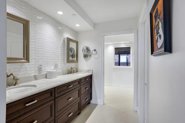 a bathroom with a double vanity sink and a mirror