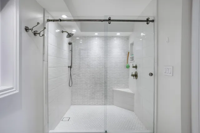 a bathroom with a shower and a bath tub