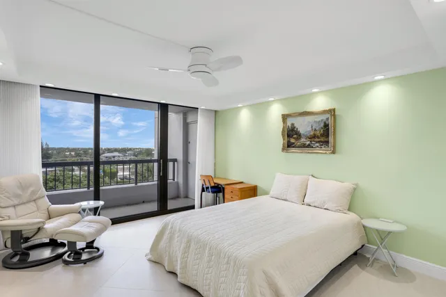 a bedroom with bed and glass window