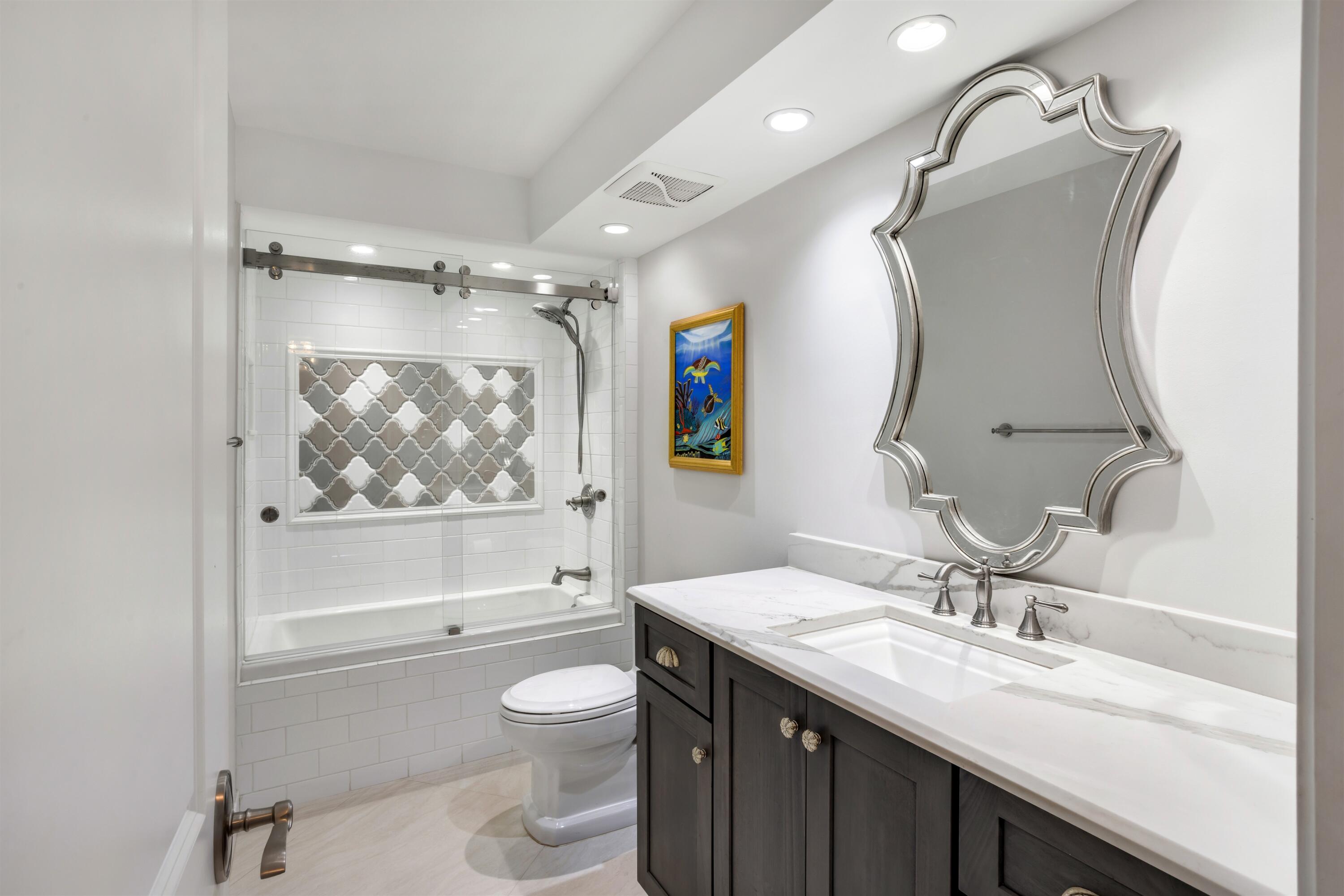 1800 South Ocean Boulevard, Unit 6B Boca Raton, FL 33432 - Photo 18 of 34 a bathroom with a sink a toilet and shower