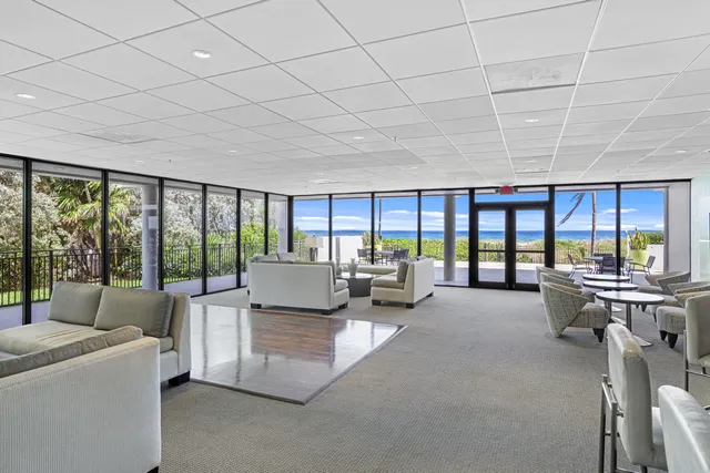 a view of a patio with a table and chairs under an umbrella