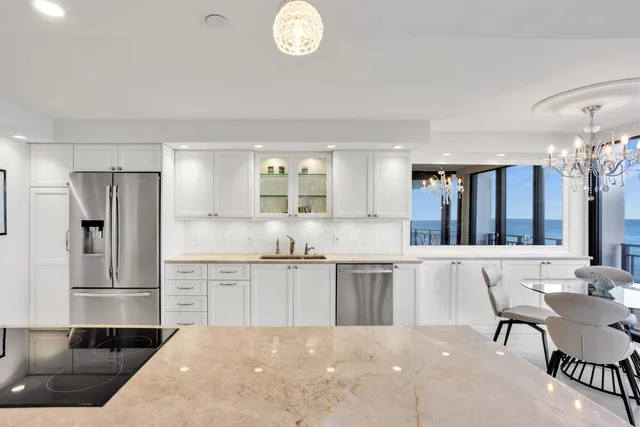 a large kitchen with cabinets and stainless steel appliances