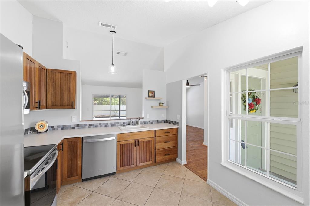 11224 Holbrook Street Spring Hill, FL 34609 - Photo 15 of 55 a kitchen with a stove sink and cabinets