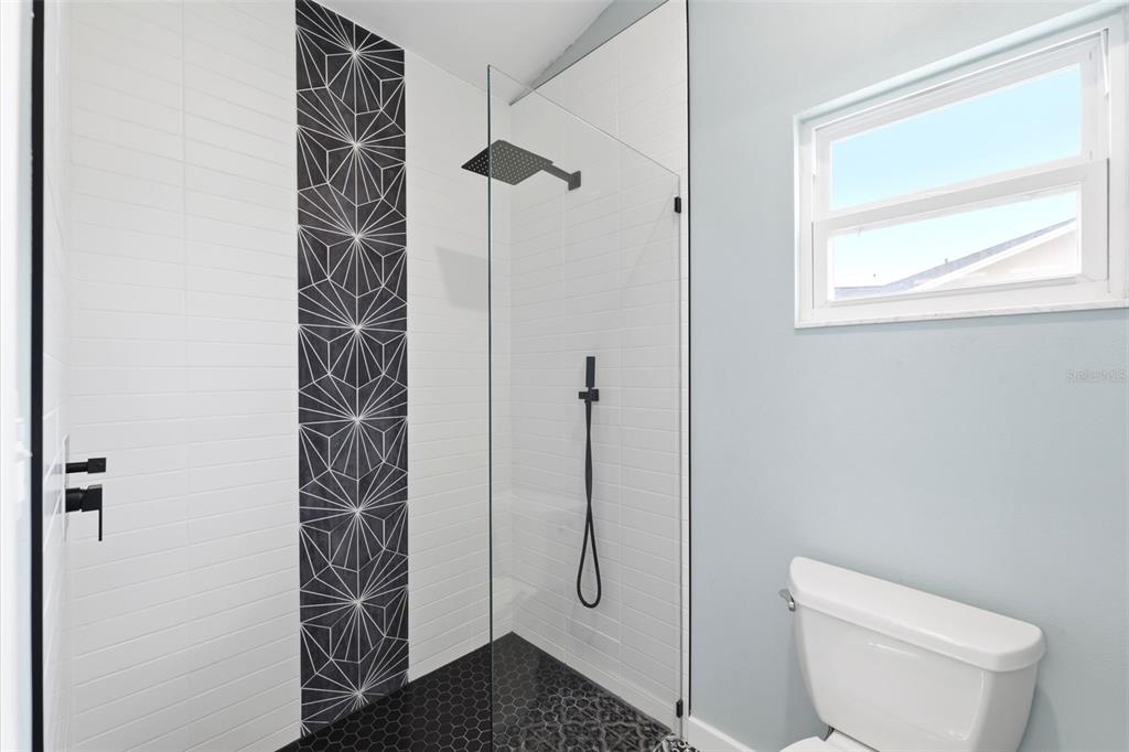 11224 Holbrook Street Spring Hill, FL 34609 - Photo 22 of 55 a bathroom with a toilet and shower