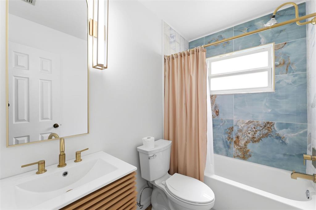 11224 Holbrook Street Spring Hill, FL 34609 - Photo 26 of 55 a bathroom with a sink toilet and shower