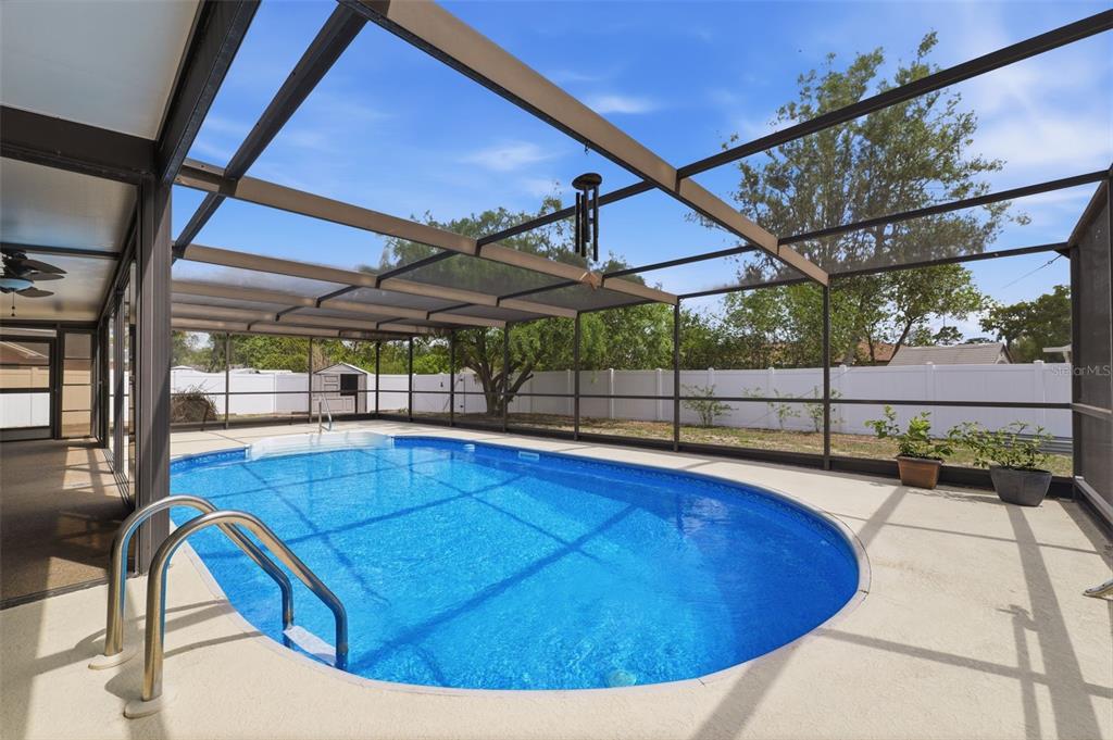 11224 Holbrook Street Spring Hill, FL 34609 - Photo 34 of 55 a view of a swimming pool with a patio