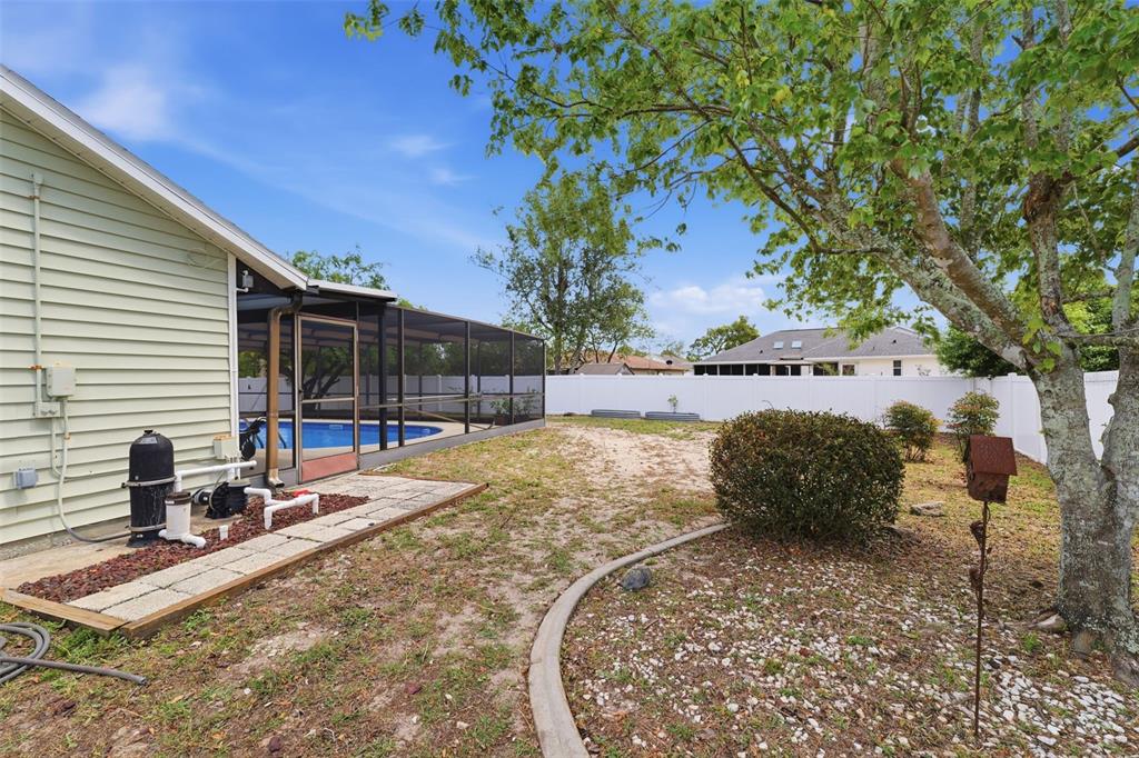 11224 Holbrook Street Spring Hill, FL 34609 - Photo 36 of 55 a view of a backyard with plants and a patio